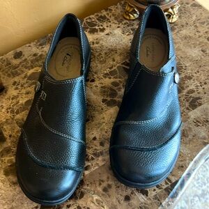 Clark’s black leather slip on shoes.
